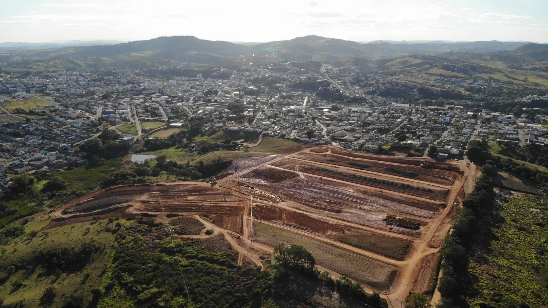 Aérea do loteamento Portal da Serra em terraplenagem, com a cidade de Perdões e a serra do Sul de Minas ao fundo