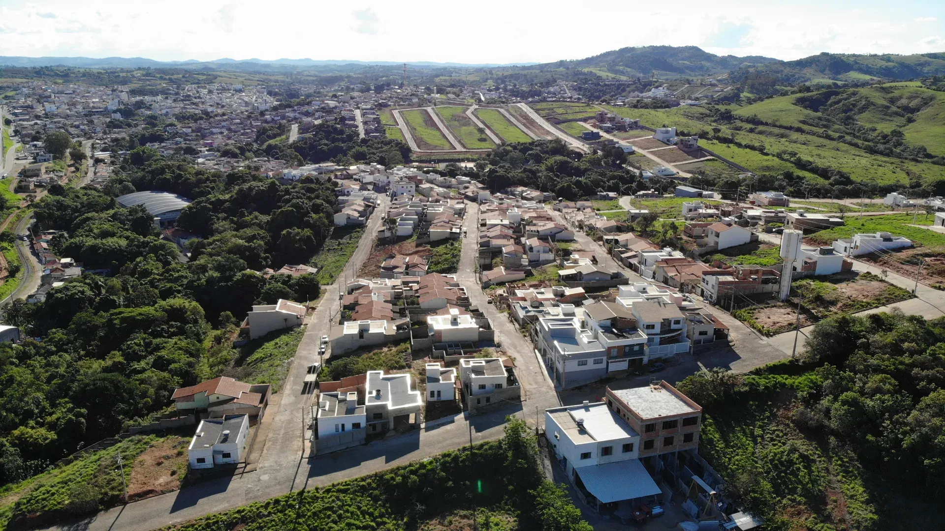 Perspectiva aérea do Jardim Centenário mostrando a expansão urbana, casas residenciais e a continuidade com a malha urbana de Perdões